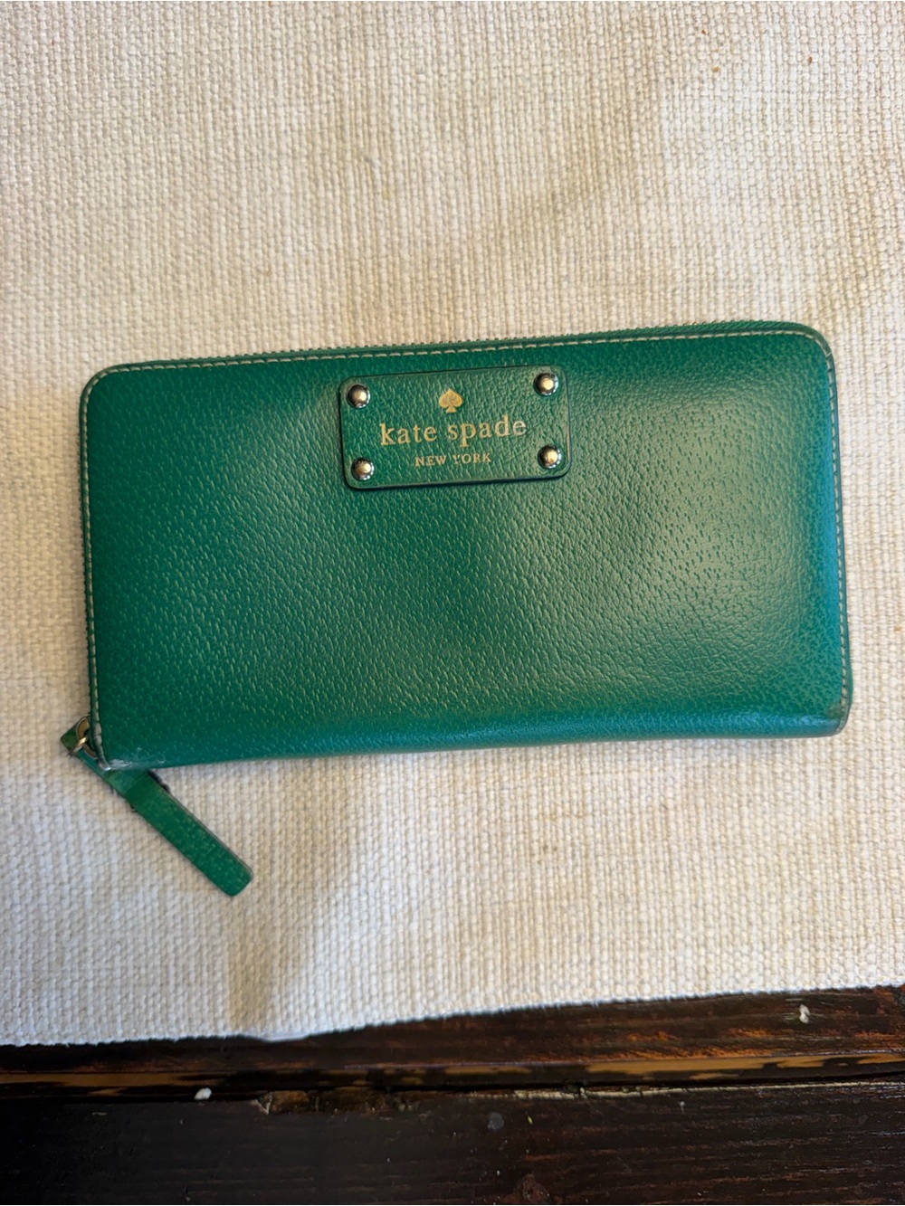 kate spade emerald zip-around leather wallet with gold logo plate
